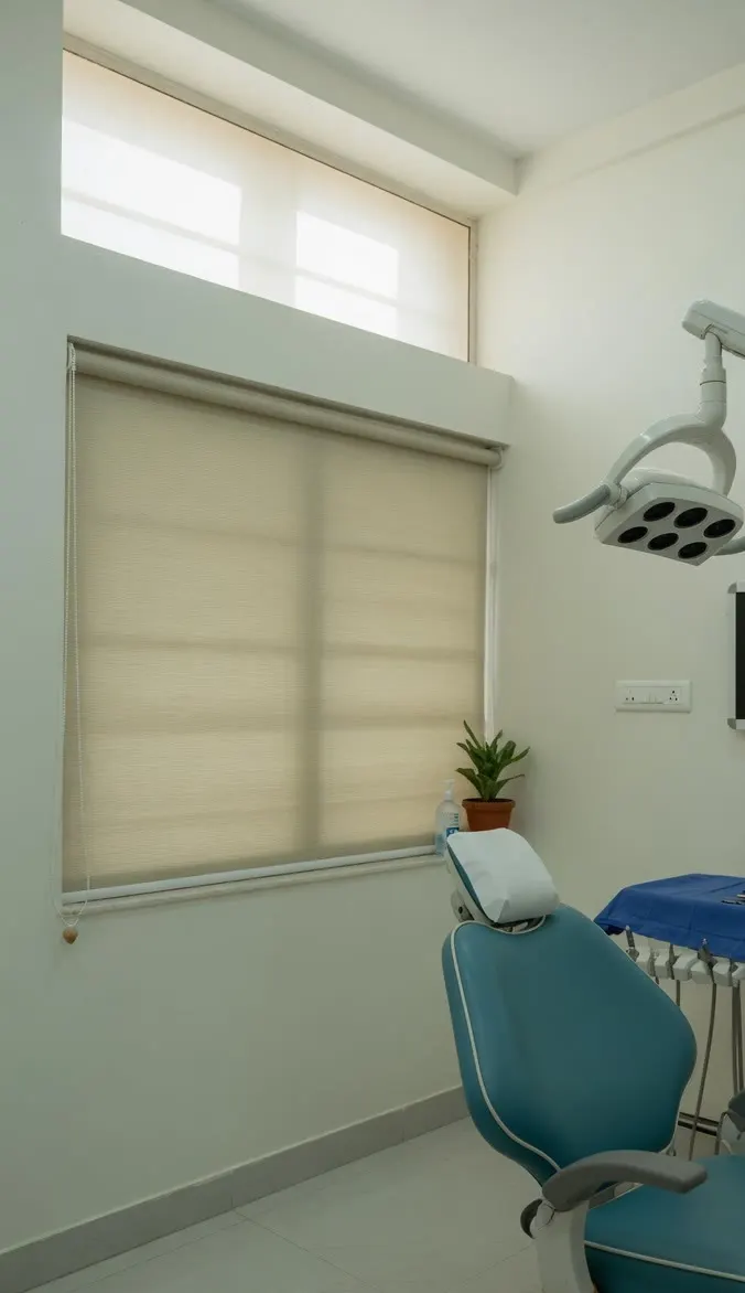 A dental chair and an overhead lamp in an empty treatment room.